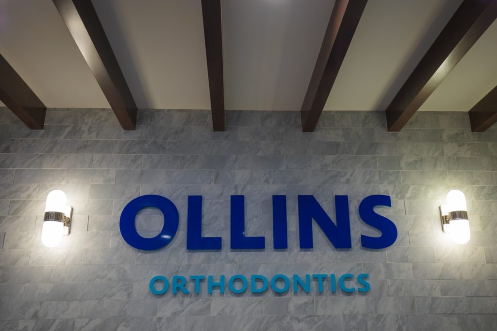 Ollins Orthodontics sign on wall