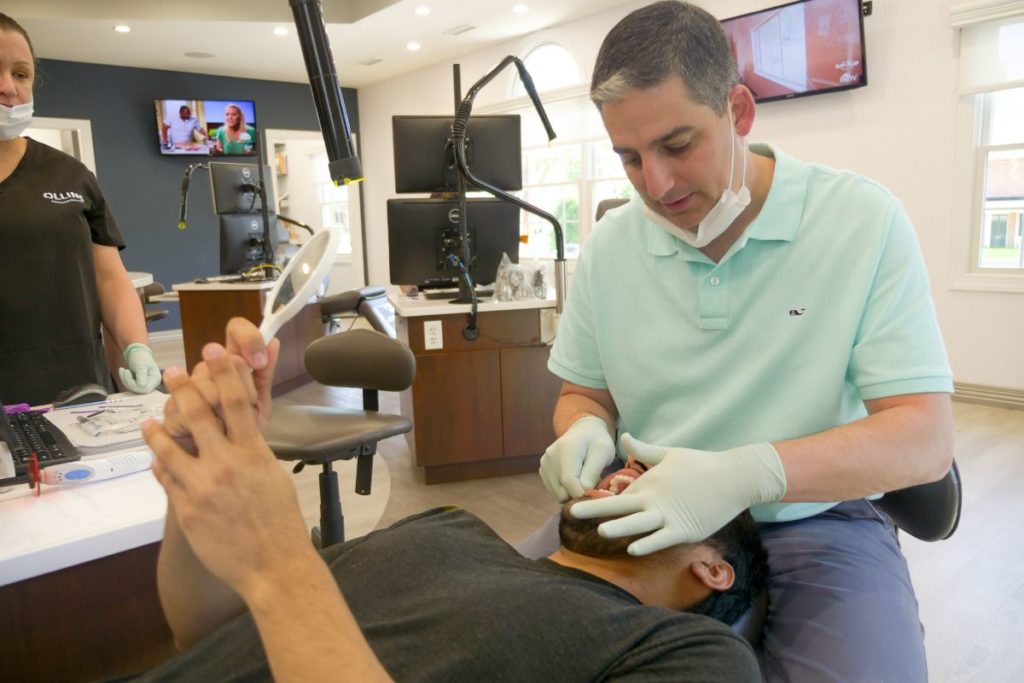 Dr. Ollins working on a patient's teeth