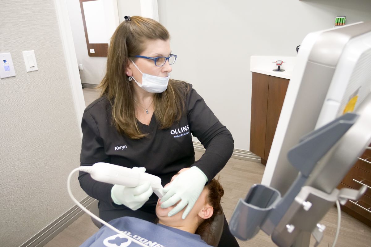 Ollins assistant scanning patient's teeth