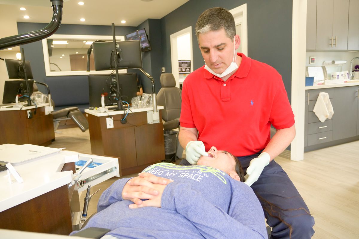 Dr. Ollins working on a patient's teeth